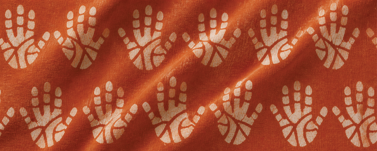 Pattern of hand prints on a red fabric
